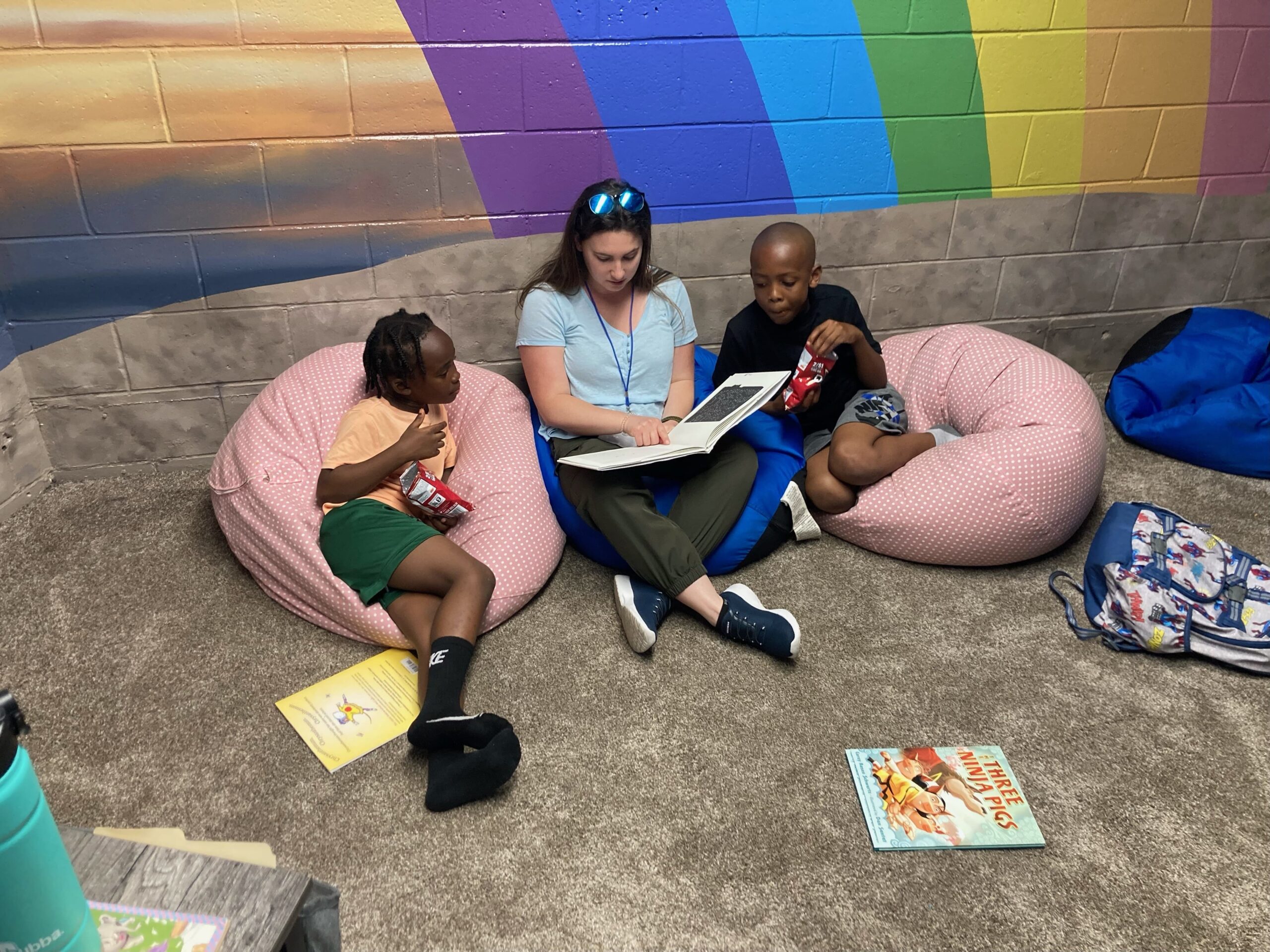 Tutor and scholars reading on the floor