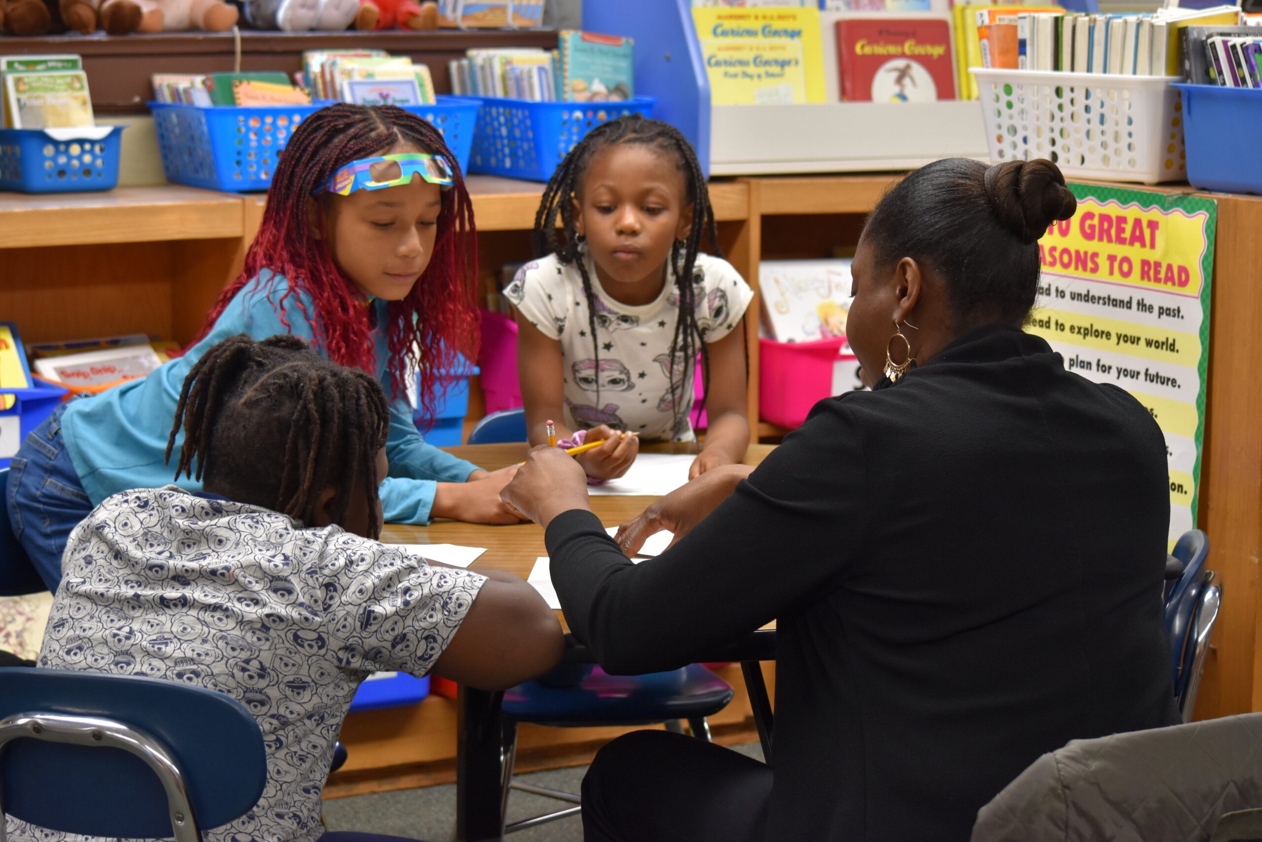 Tutor sitting with scholars