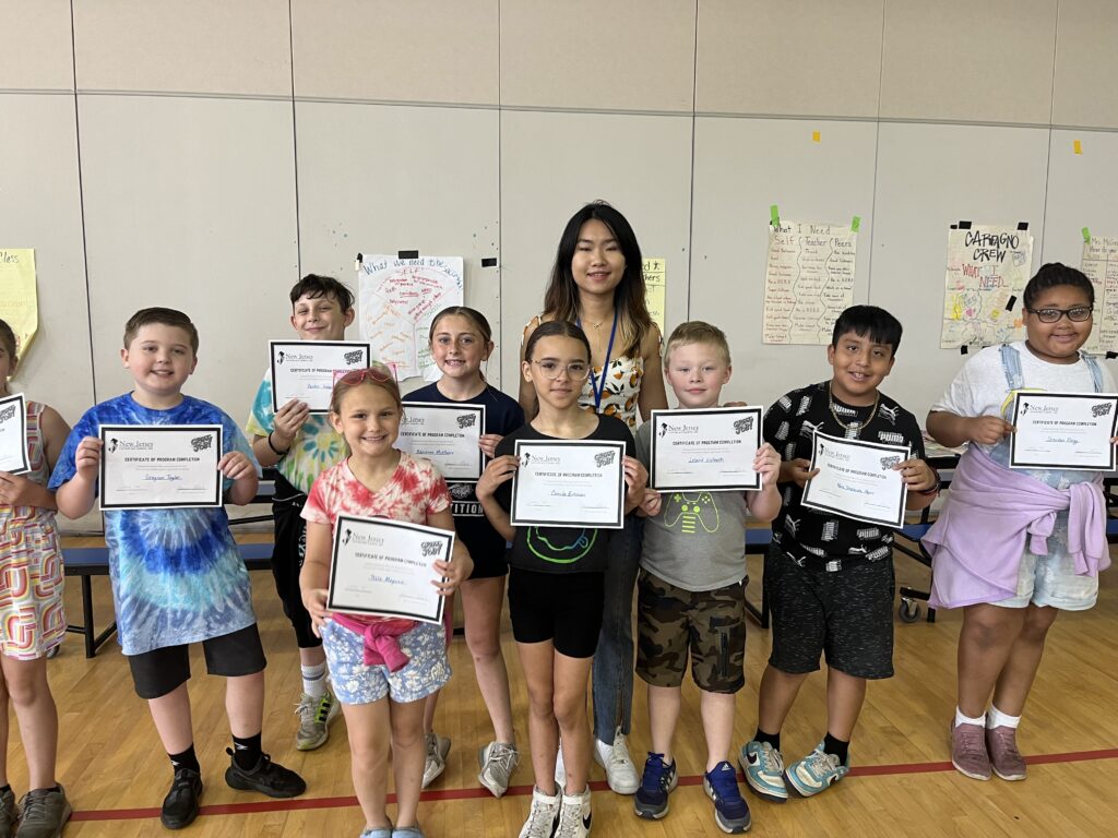 tutor with scholars holding certificates