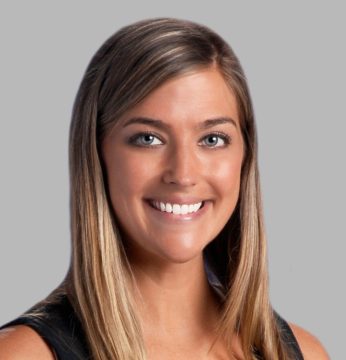 Headshot of Collins on display smiling at the camera